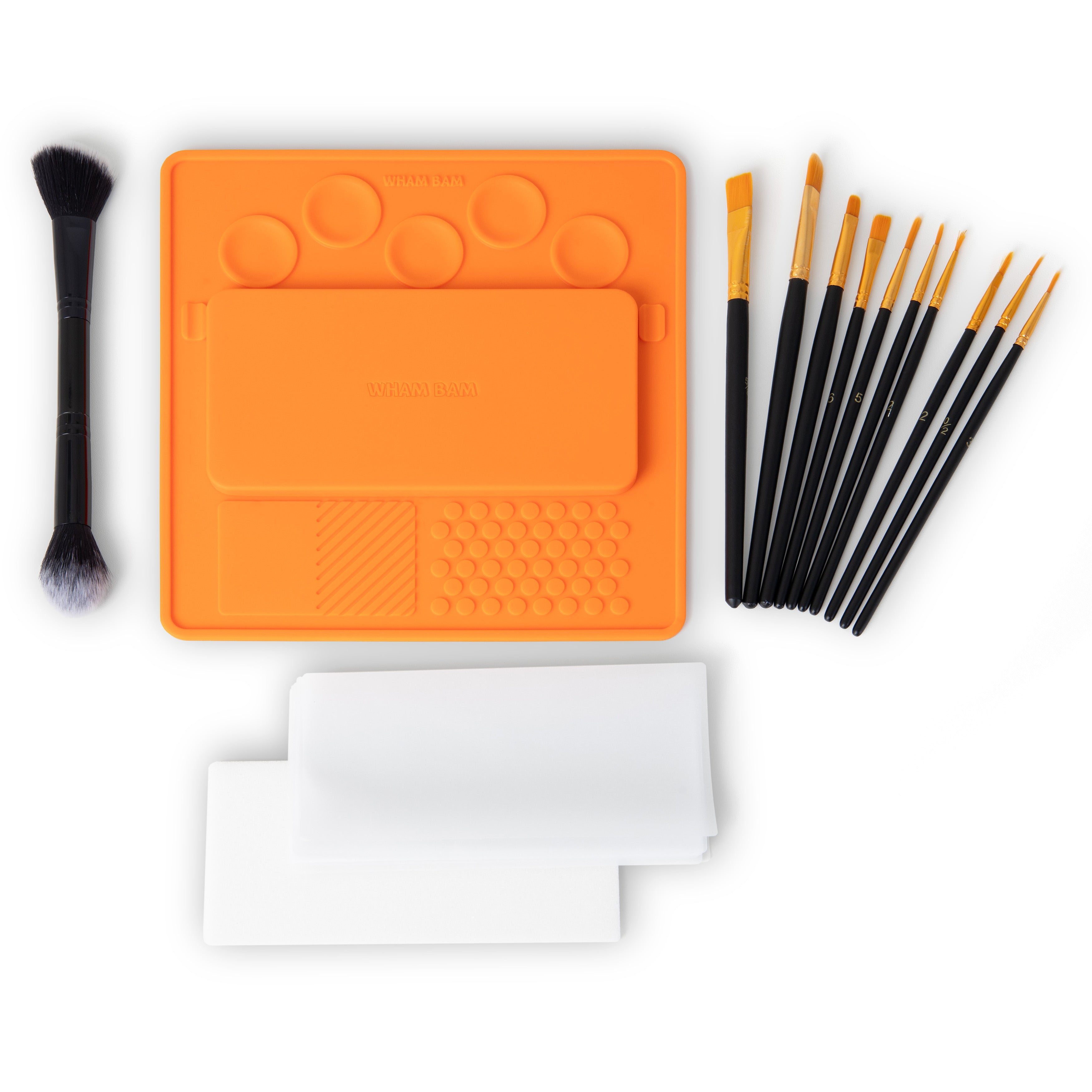 Close-up of the silicone mixing palette showing mixing wells and brush rests.
