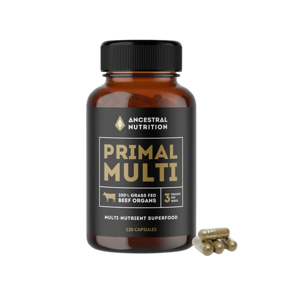 Ancestral Primal Multi bottle with a background of fresh vegetables, highlighting its whole food ingredients.