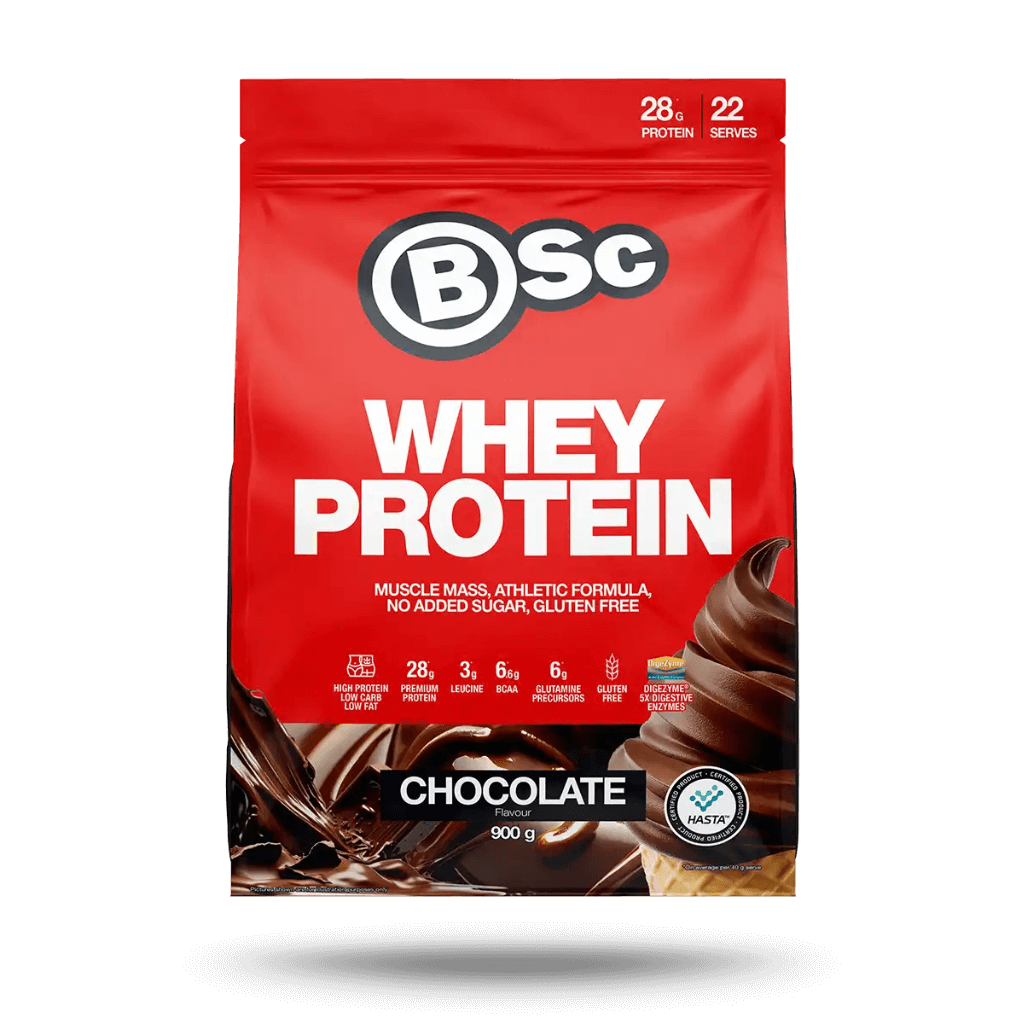 A scoop of whey protein powder next to a shaker bottle for muscle gain