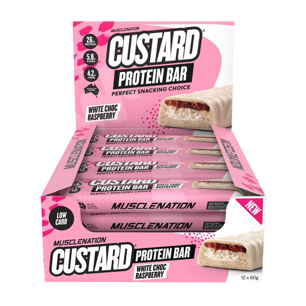 Hand holding Muscle Nation custard protein bar during outdoor workout