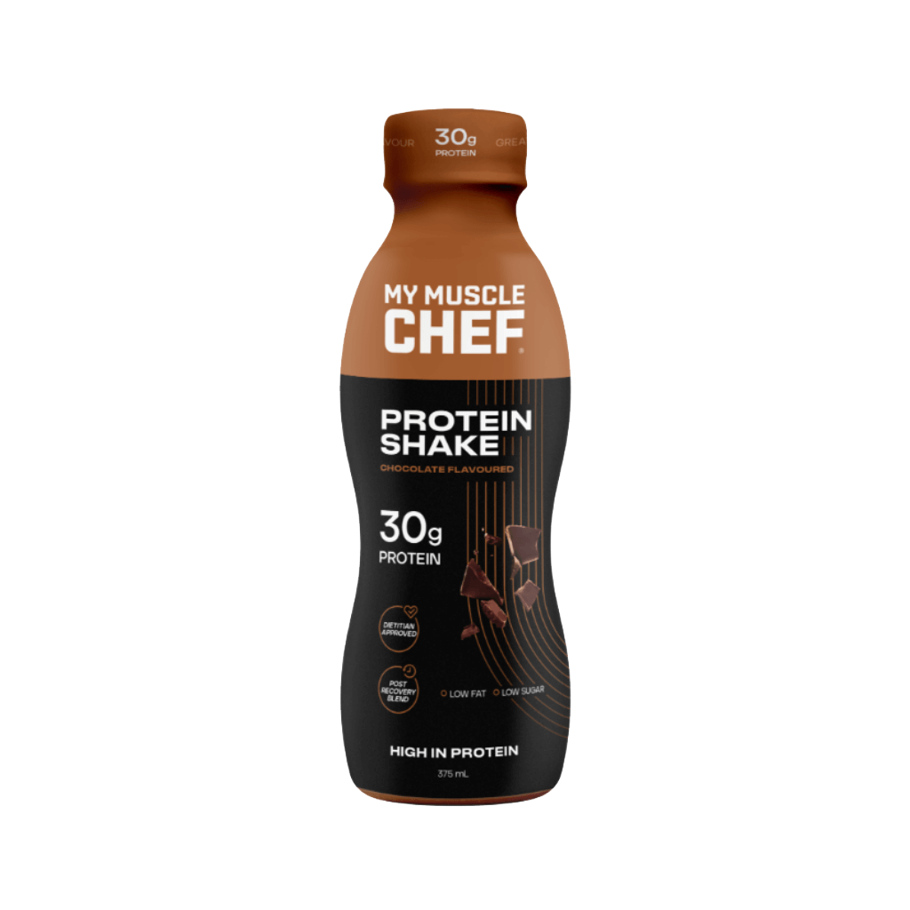 Ultimate Muscle Recovery Protein Shake in a glass with a scoop of protein powder beside it, showcasing the rich texture and flavor.