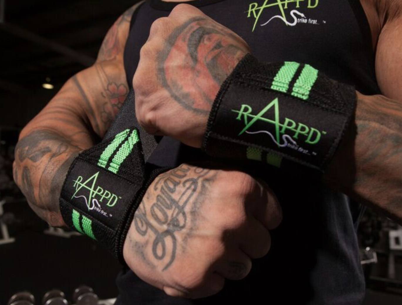 Person applying Rappd wrist wraps before a lifting session, highlighting the thumb loop feature.