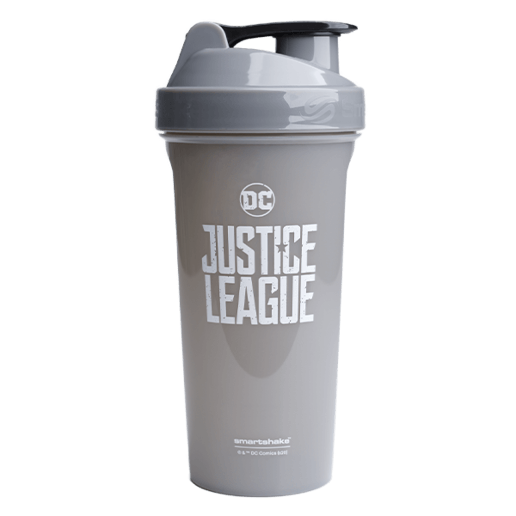 Hand gripping protein shaker during outdoor HIIT session, emphasizing durability and grip.