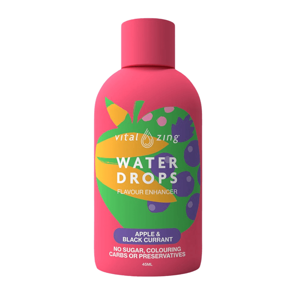 Close-up of flavored water drops being added to a glass of water for enhanced hydration